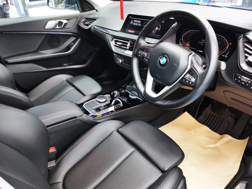 The BMW 216i parked in the workshop, freshly coated.
