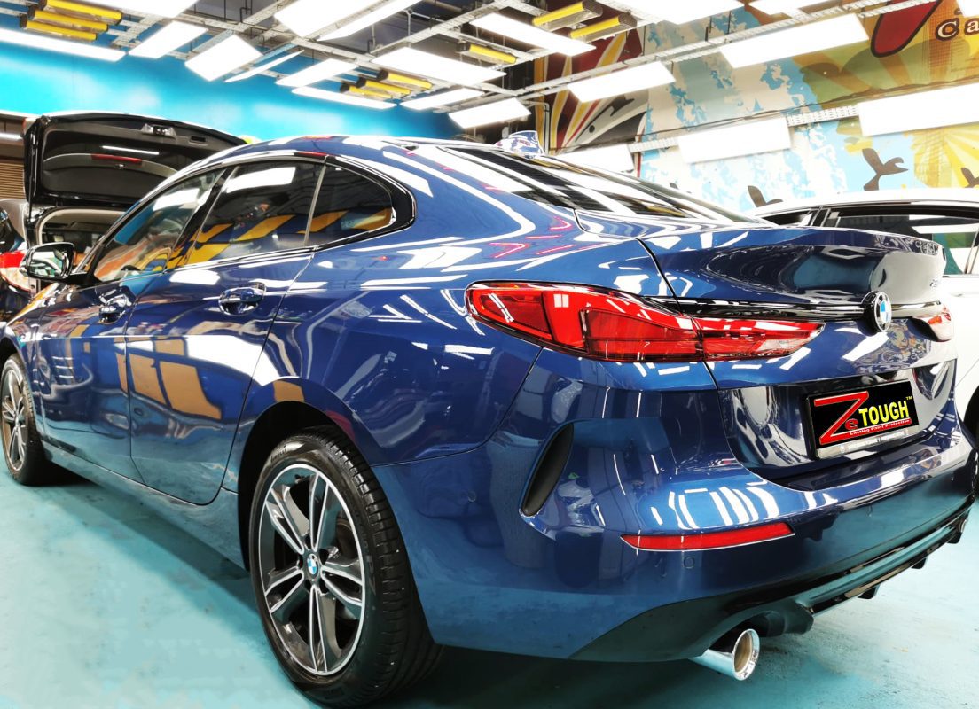 Rear quarter of the BMW 216i, glossy and protected.