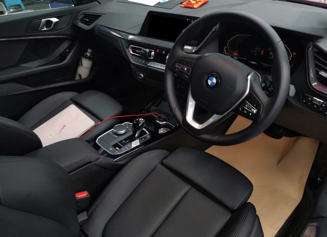 The BMW 216i parked in the workshop, freshly coated.