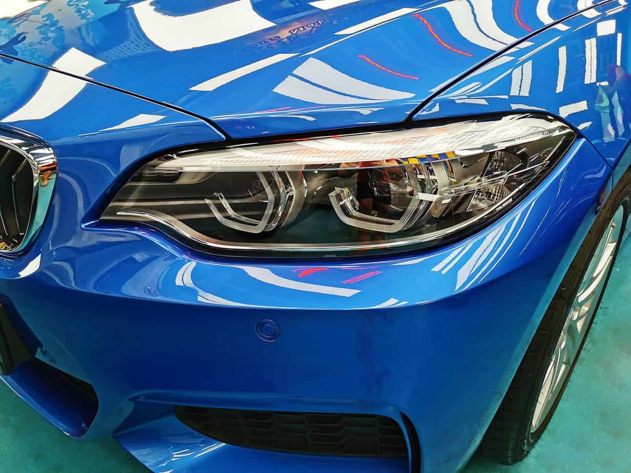The 218i's coated paintwork showing clean reflections.