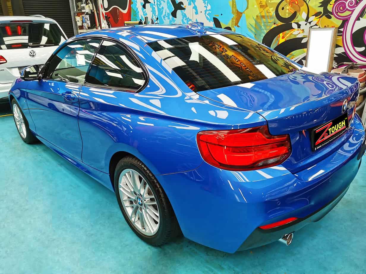 Rear quarter of the BMW 218i, glossy and protected.