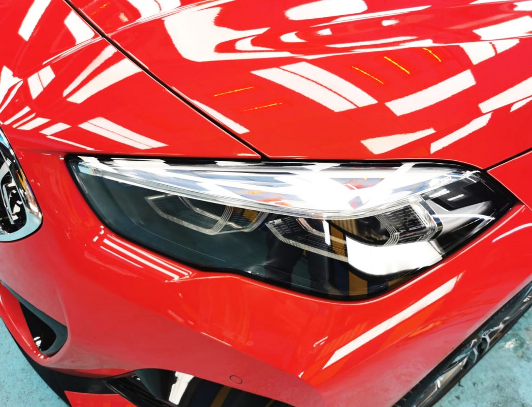 The 218i's coated paintwork showing clean reflections.