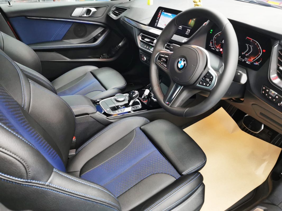 The BMW 218i parked in the workshop, freshly coated.