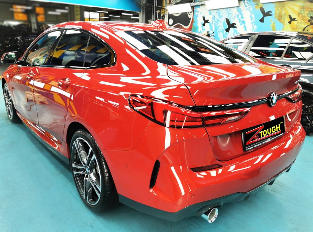 Rear quarter of the BMW 218i, glossy and protected.