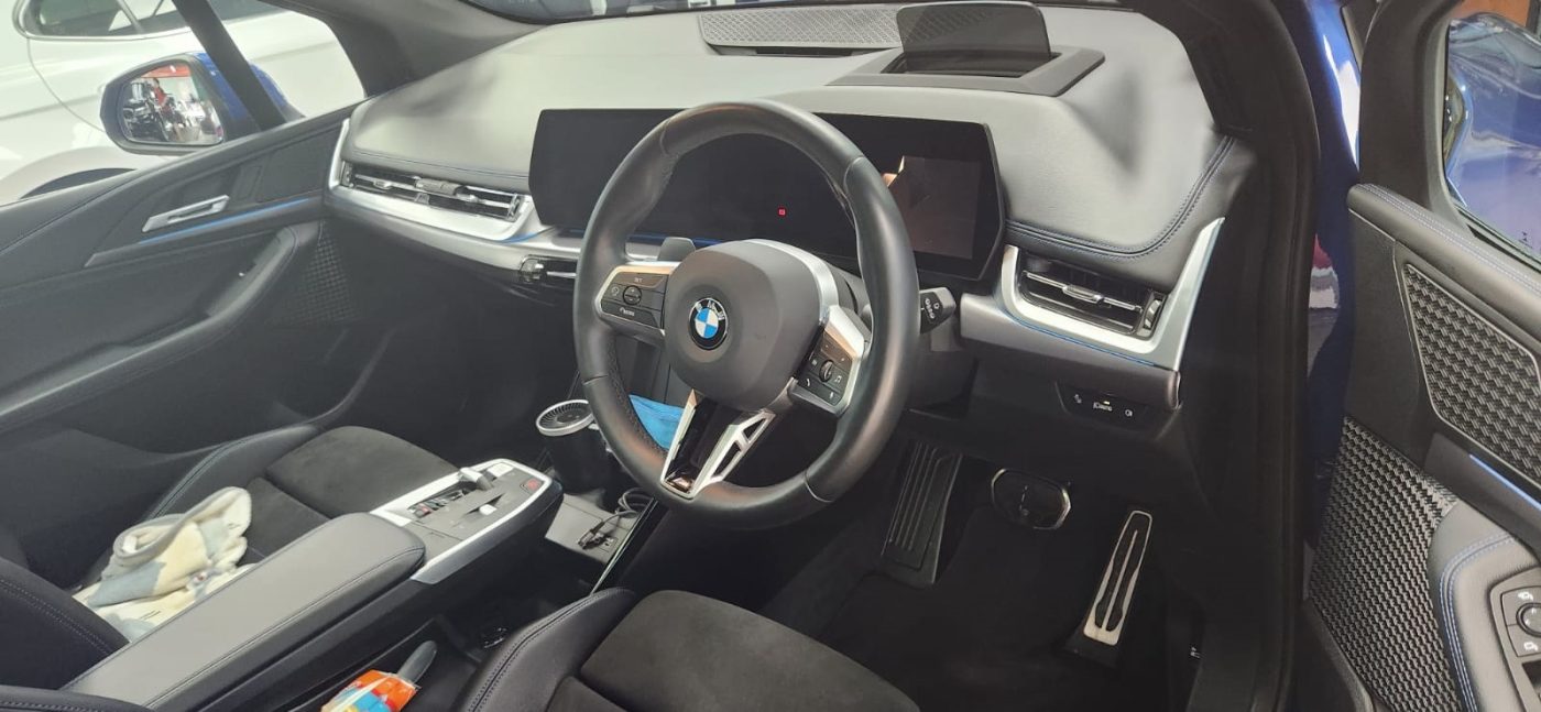 The BMW 218i parked in the workshop, freshly coated.