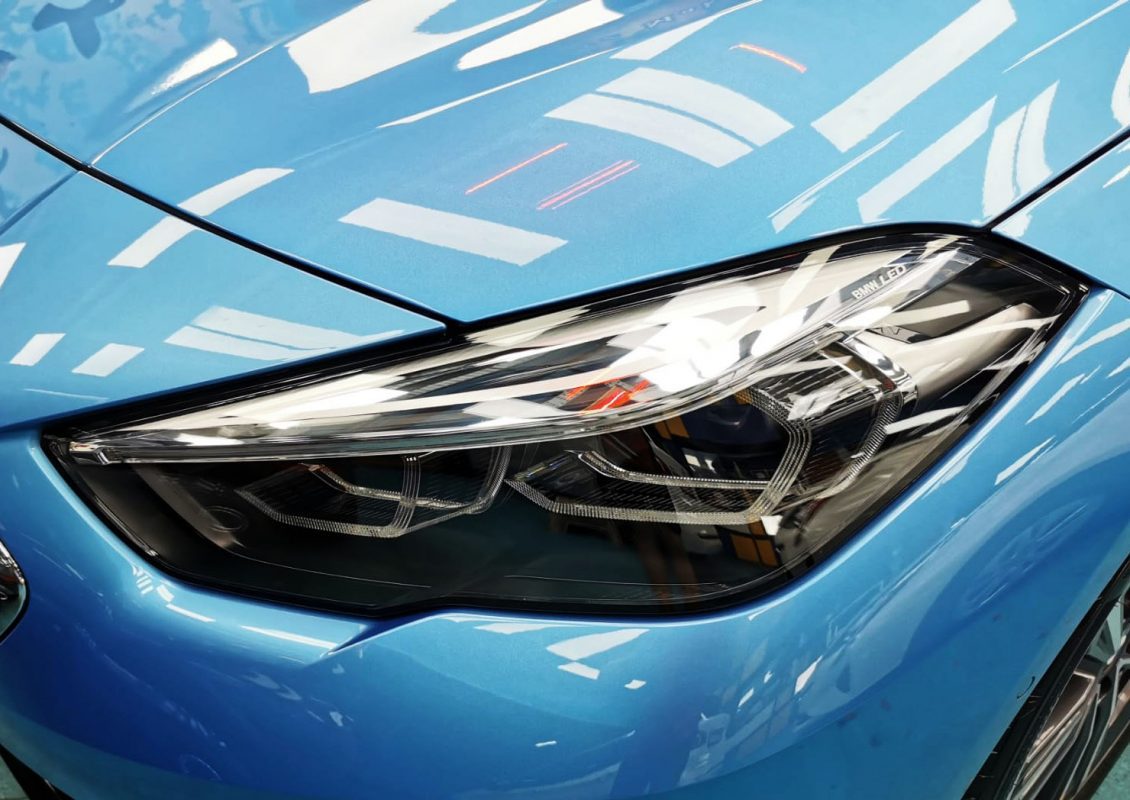 The 218i's coated paintwork showing clean reflections.