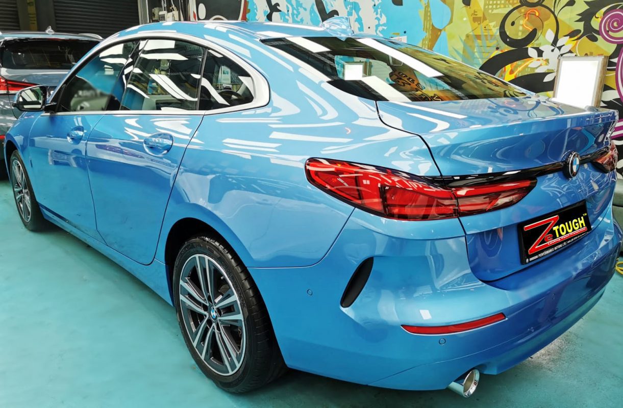 Rear quarter of the 218i, glossy and protected.