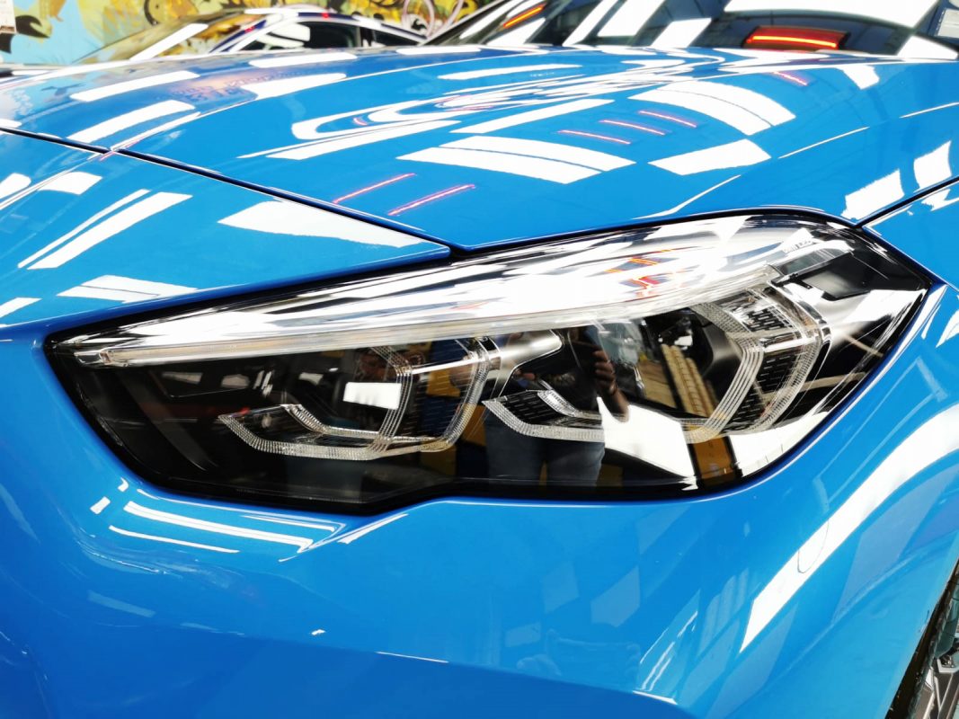 The 218i's coated paintwork showing clean reflections.