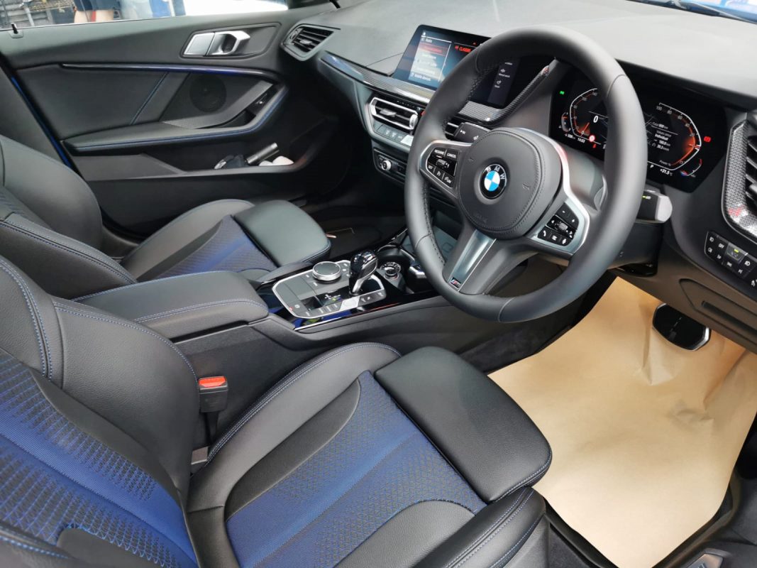 The BMW 218i parked in the workshop, freshly coated.