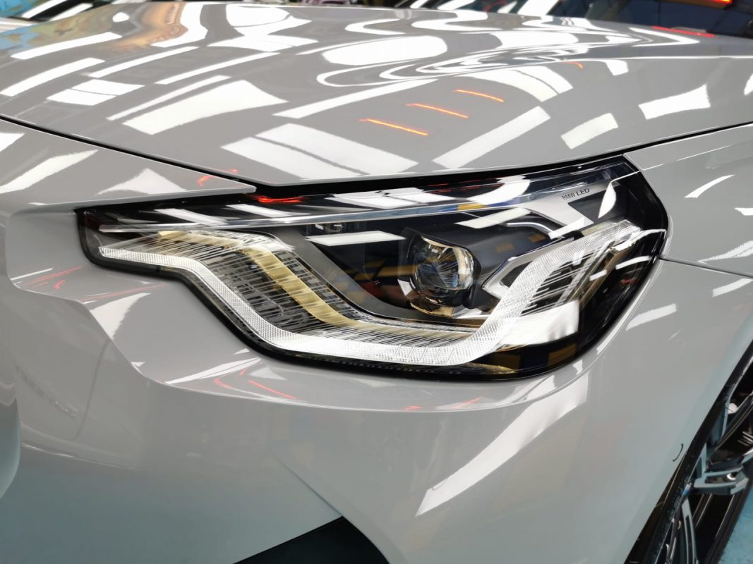 The 220i's coated paintwork showing clean reflections.
