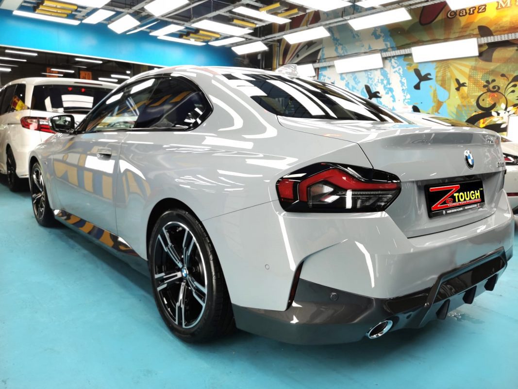 Rear quarter of the BMW 220i, glossy and protected.