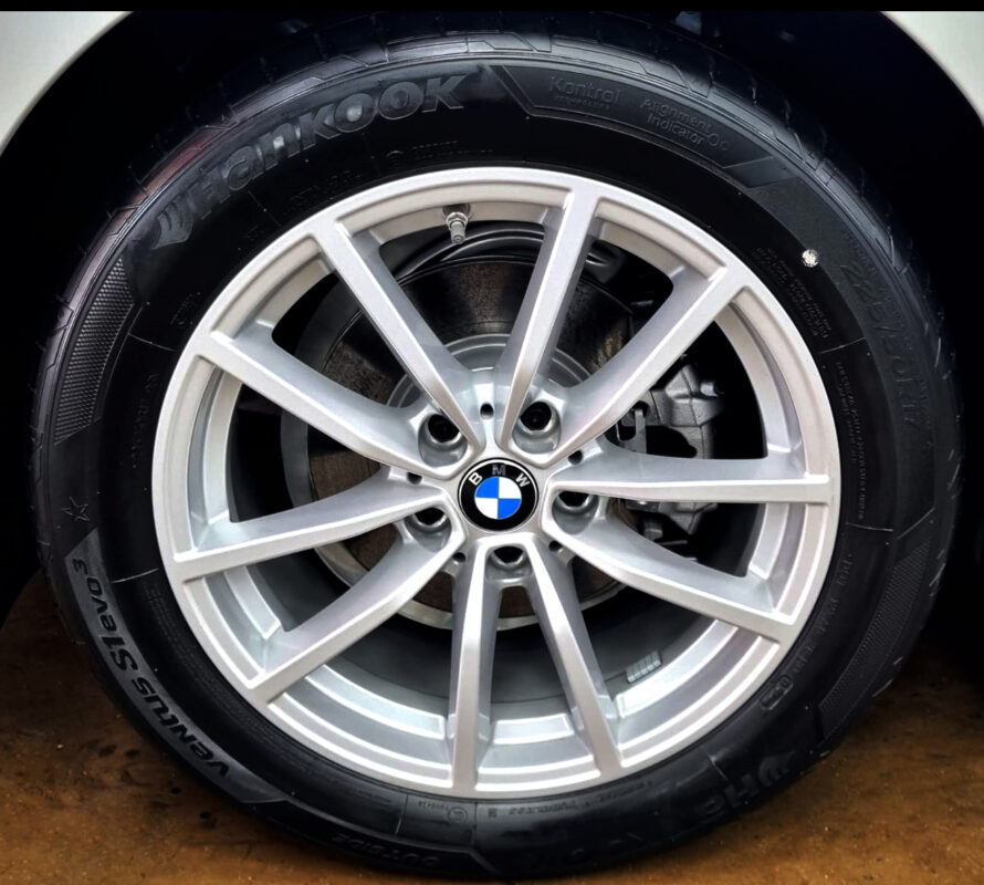 Rear quarter of the BMW 3 Series, glossy and protected.