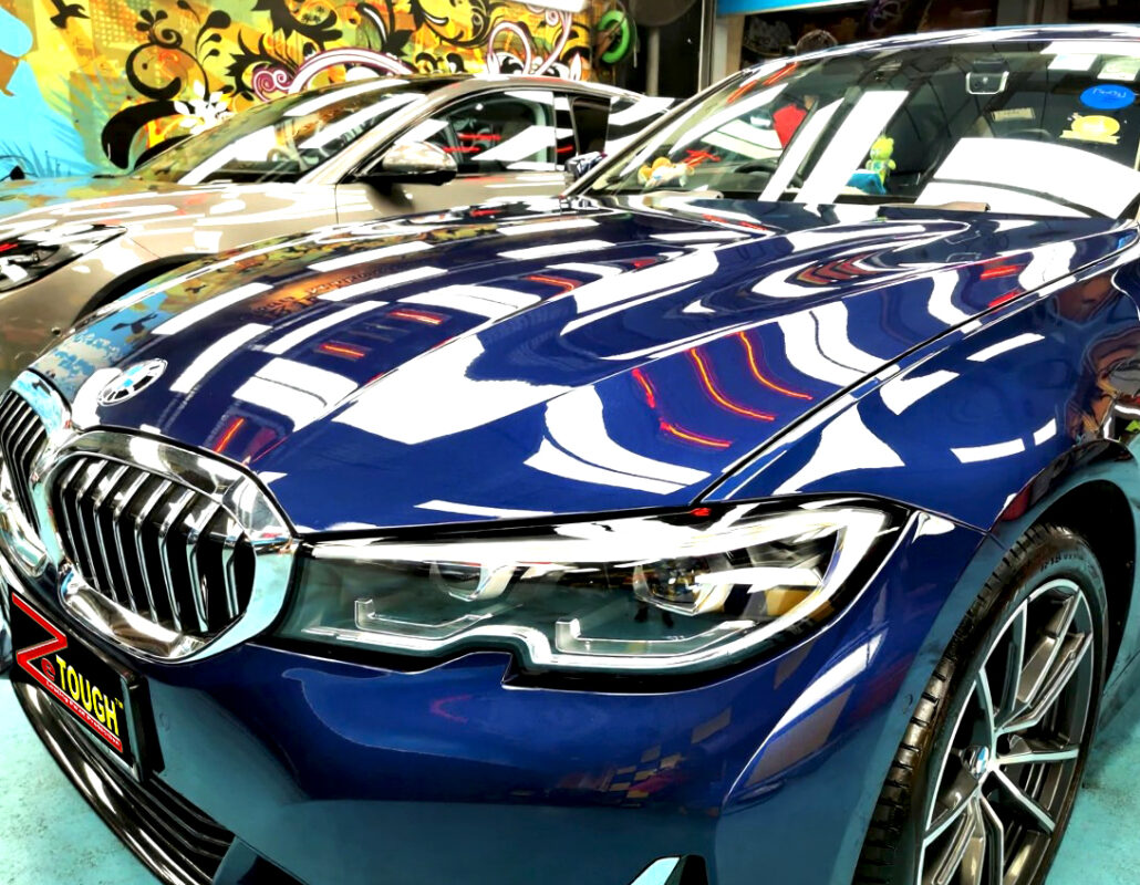 The BMW 3 Series's coated paintwork under workshop lighting.