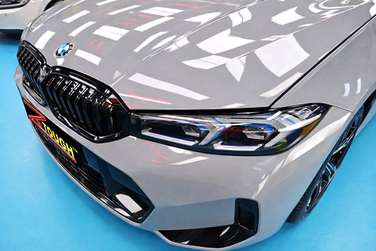 The BMW 3 Series's coated paintwork under workshop lighting.