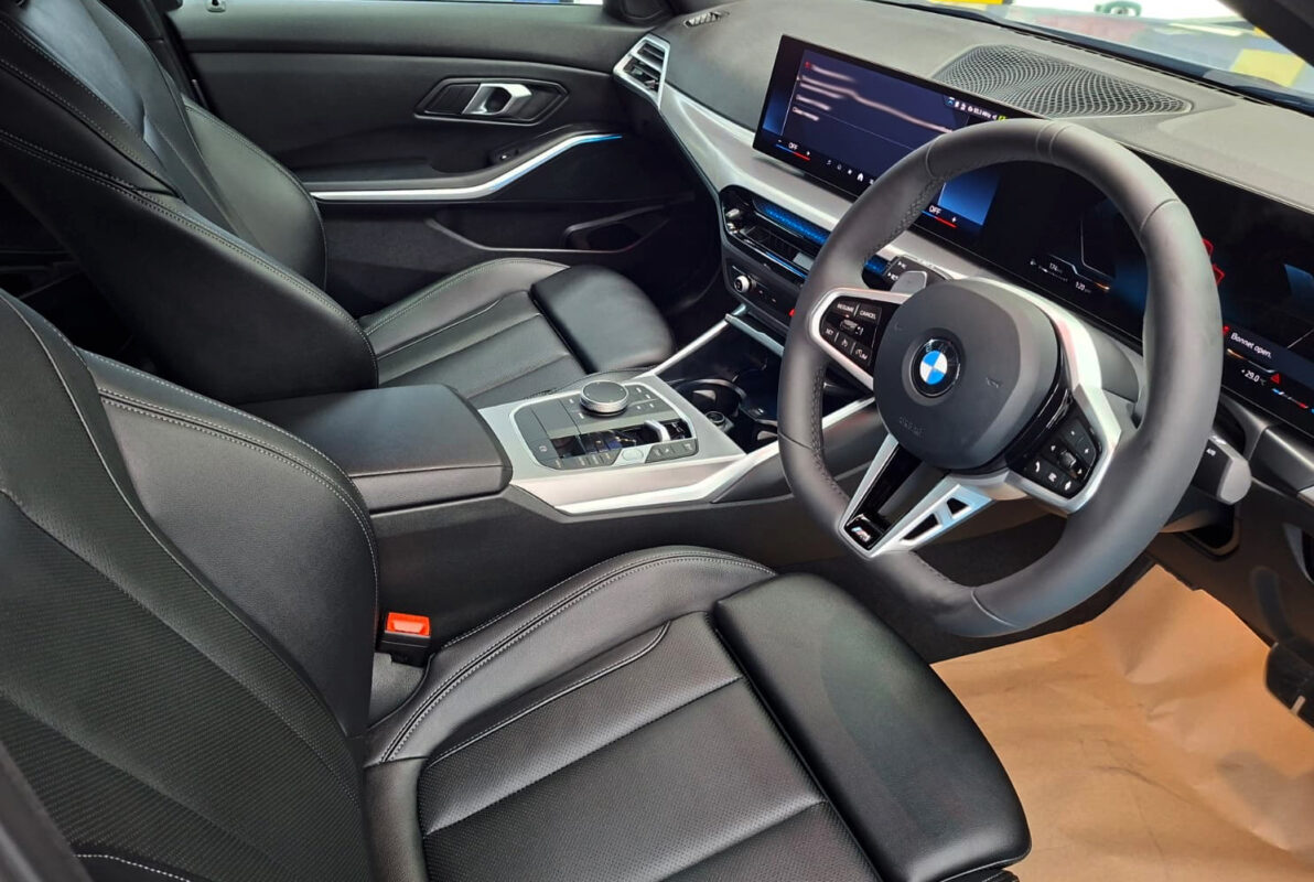 Reflections across the coated panels of the BMW 3 Series.