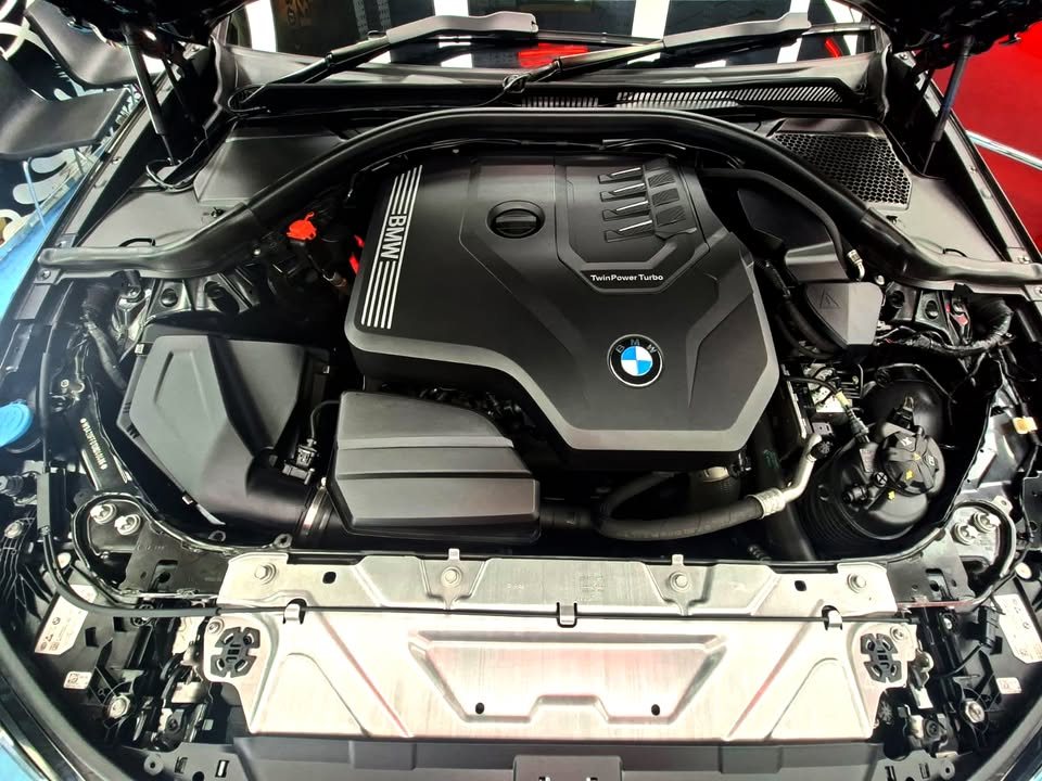 Engine bay with the BMW engine cover.