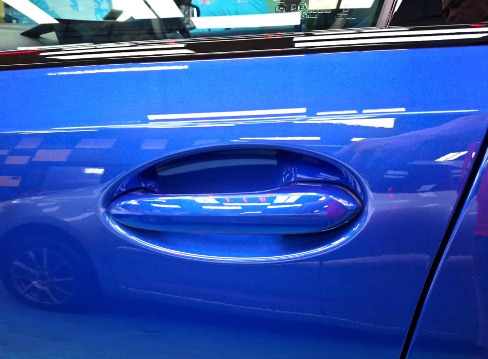 Close-up of the blue door panel and door handle.