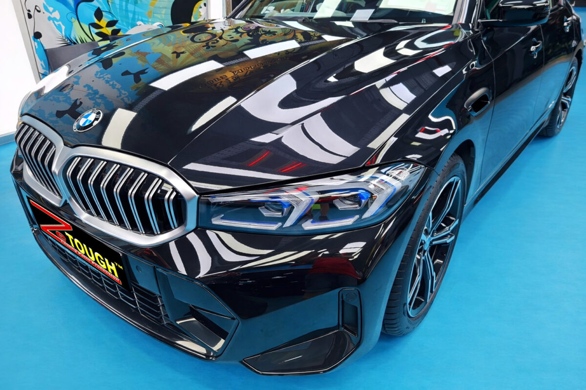 The BMW 3 Series's coated paintwork under workshop lighting.