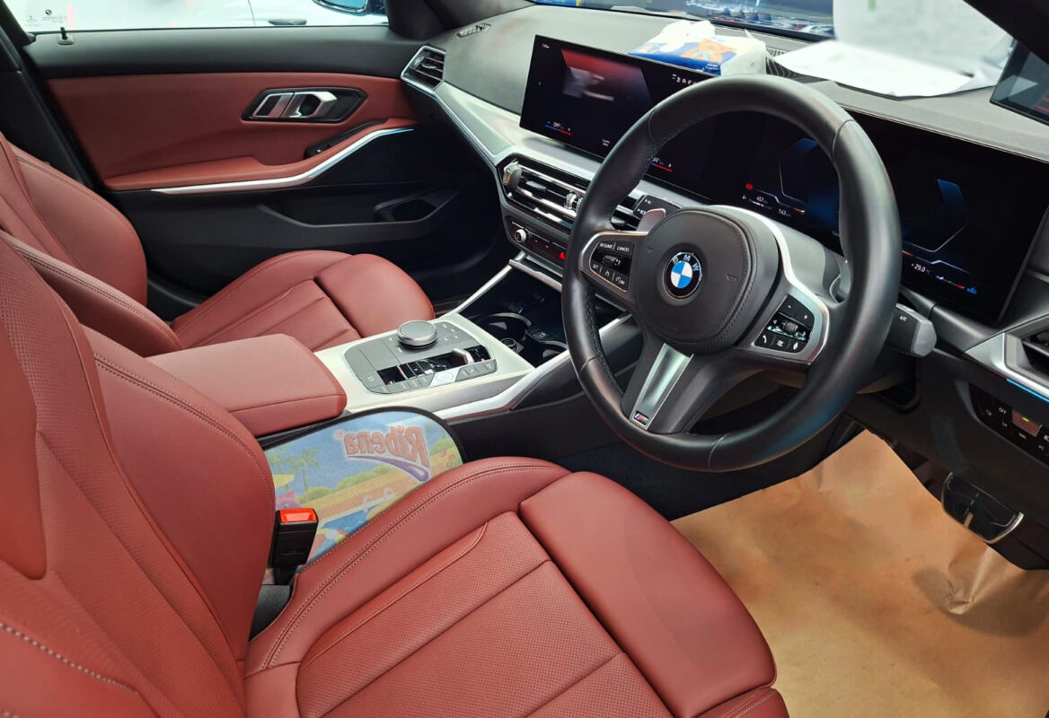 Reflections across the coated panels of the BMW 3 Series.