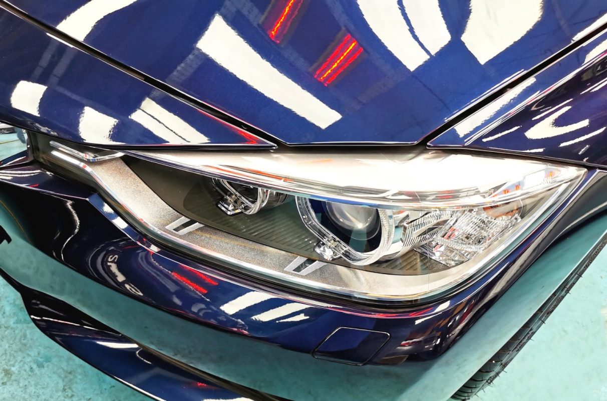 The 316i's coated paintwork showing clean reflections.