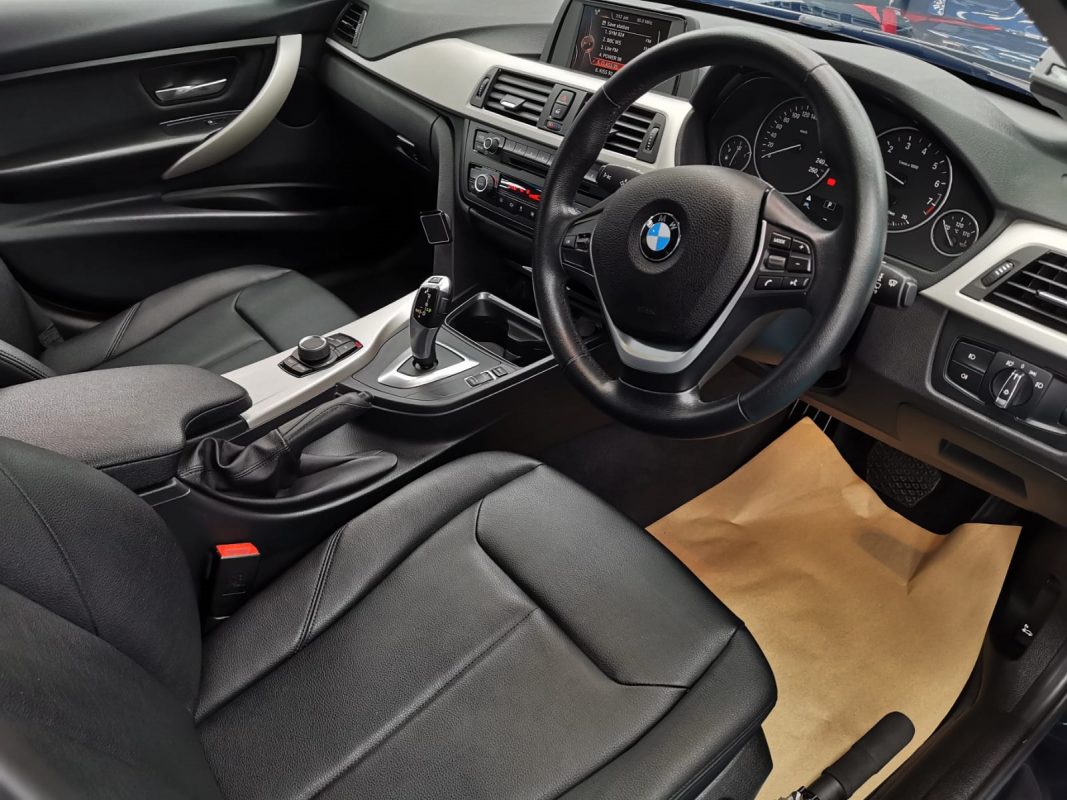 The BMW 316i parked in the workshop, freshly coated.