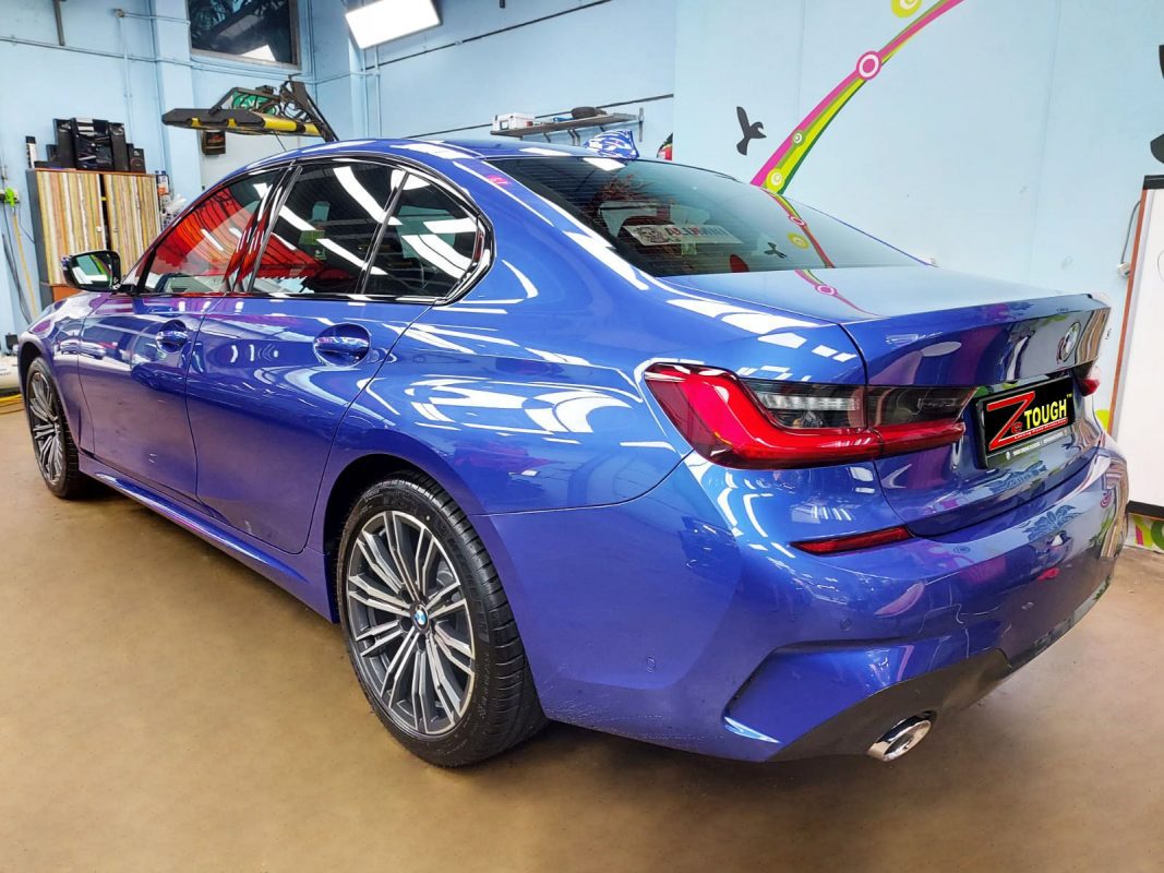 Rear quarter of the BMW 318, glossy and protected.