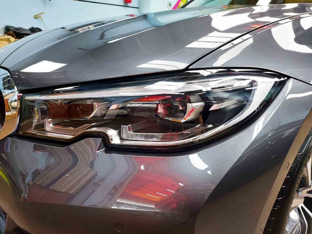The 318i's coated paintwork showing clean reflections.