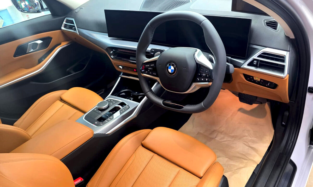 The BMW 318i parked in the workshop, freshly coated.