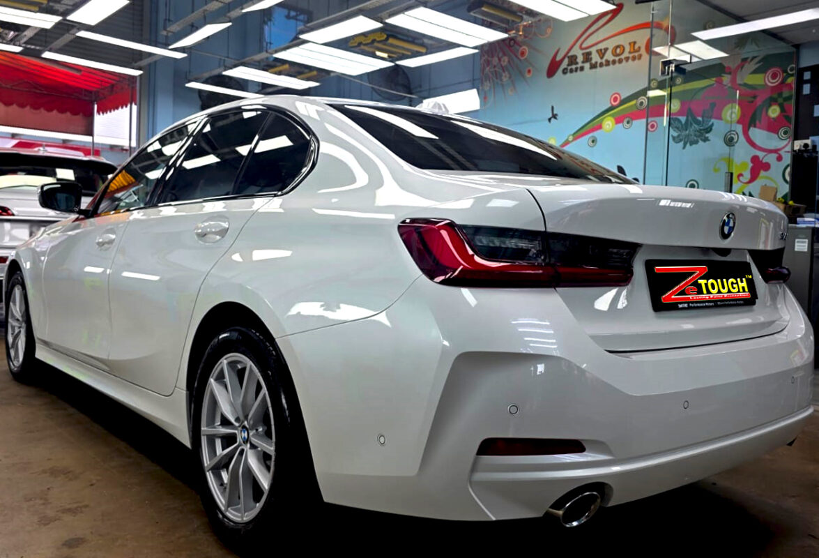 Rear quarter of the BMW 318i, glossy and protected.