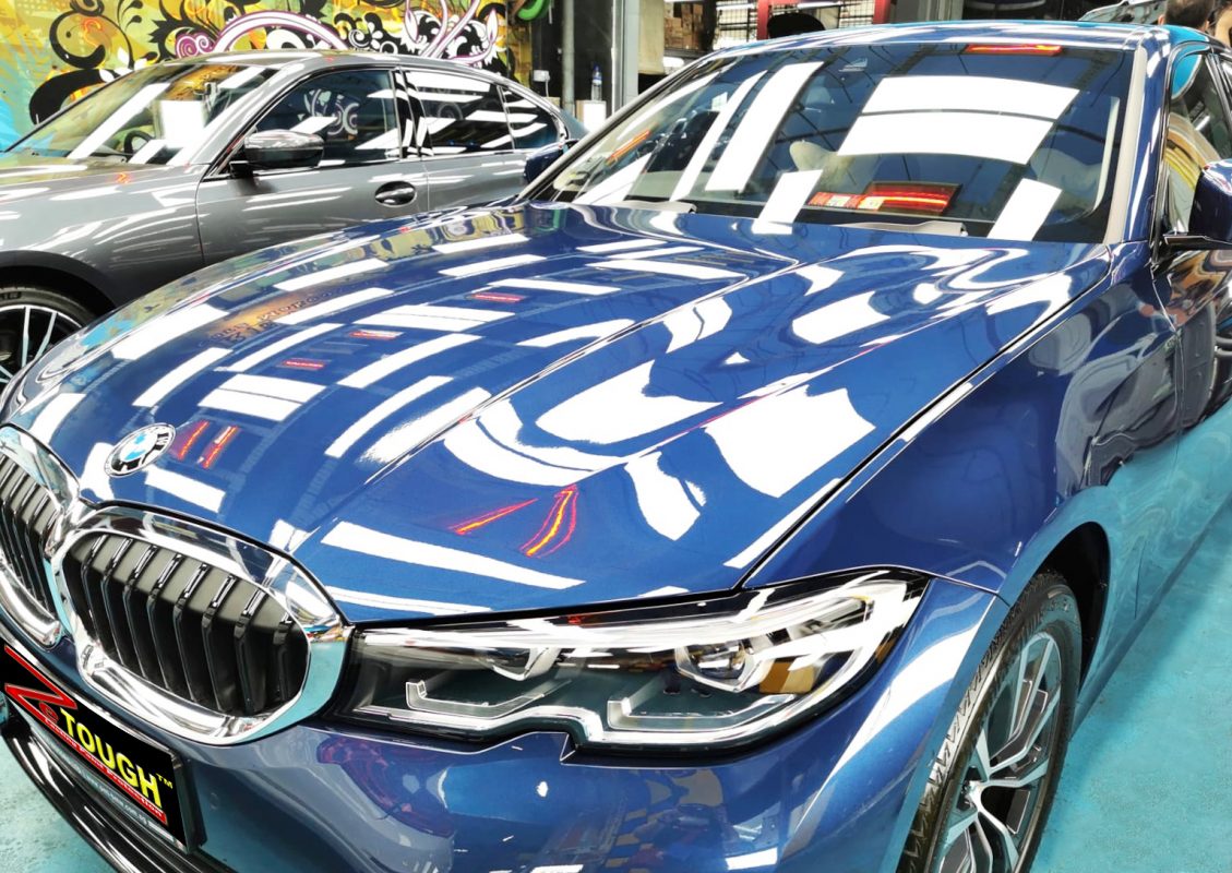 The BMW 318i from a side angle after the ceramic coating.