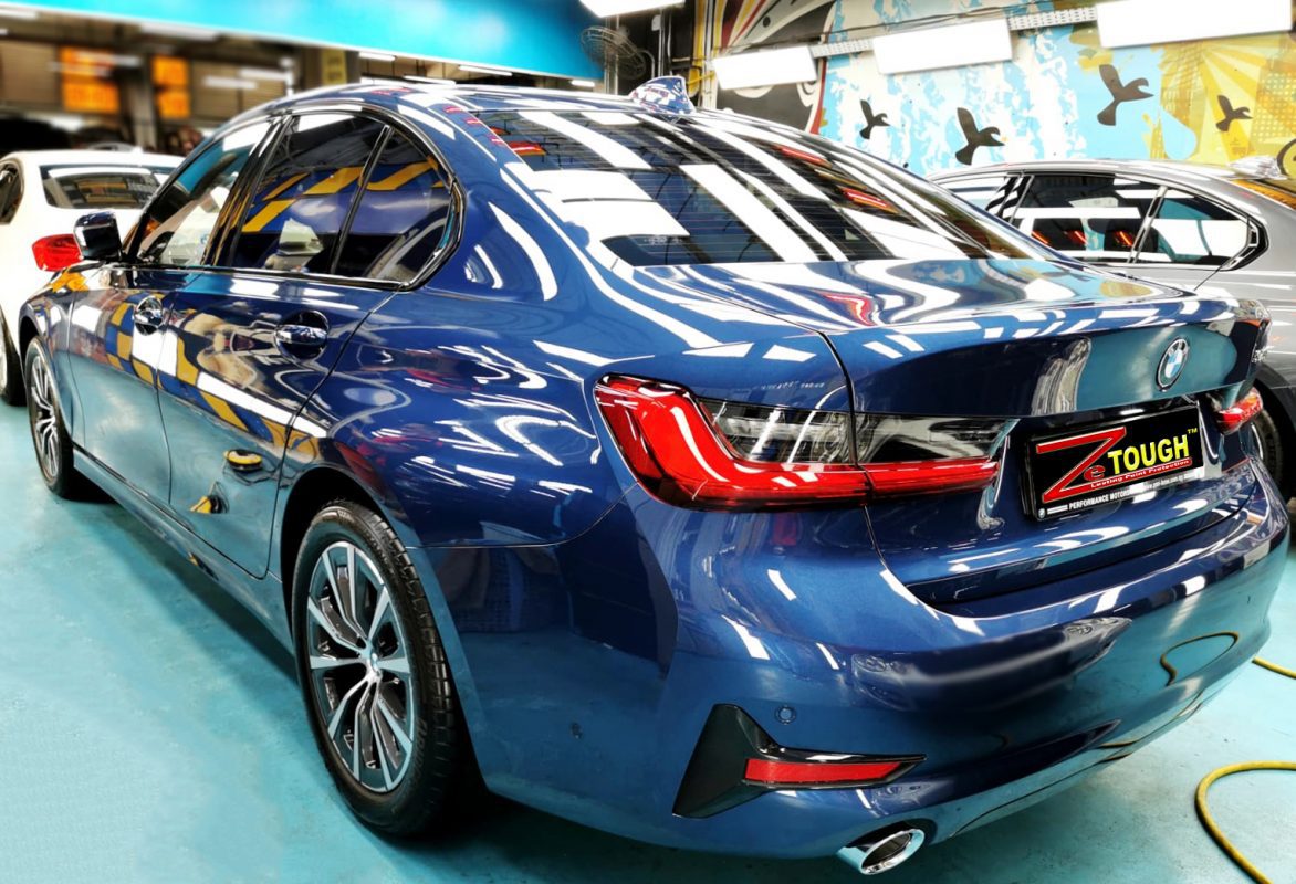 Rear quarter of the BMW 318i, glossy and protected.