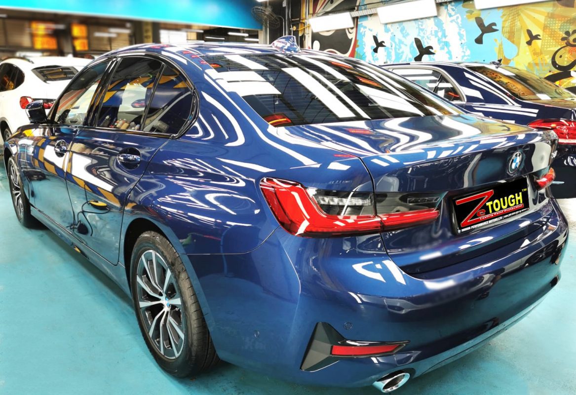 Rear quarter of the BMW 318i, glossy and protected.