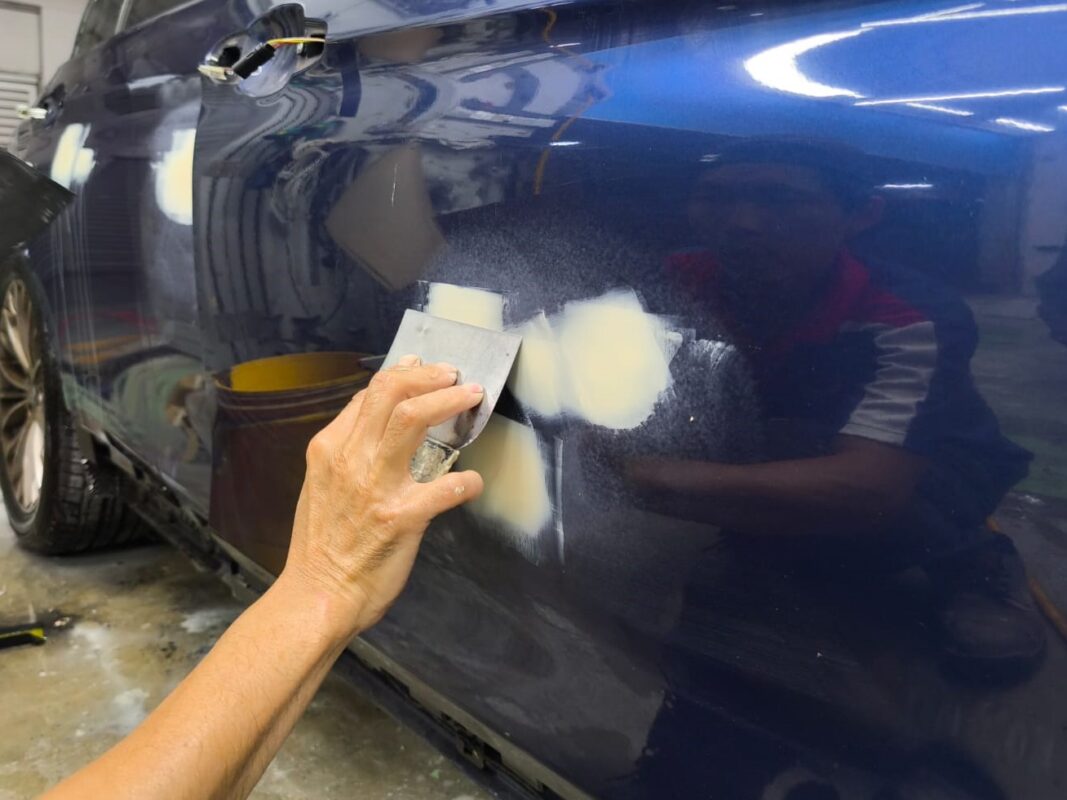 The body surface being checked and patched for imperfections.