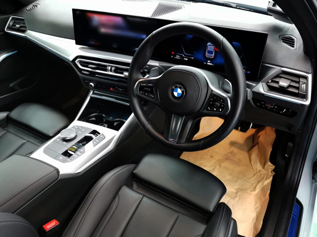 The BMW 318i parked in the workshop, freshly coated.