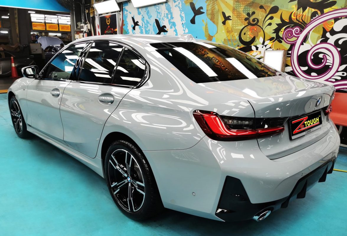 Rear quarter of the BMW 318i, glossy and protected.