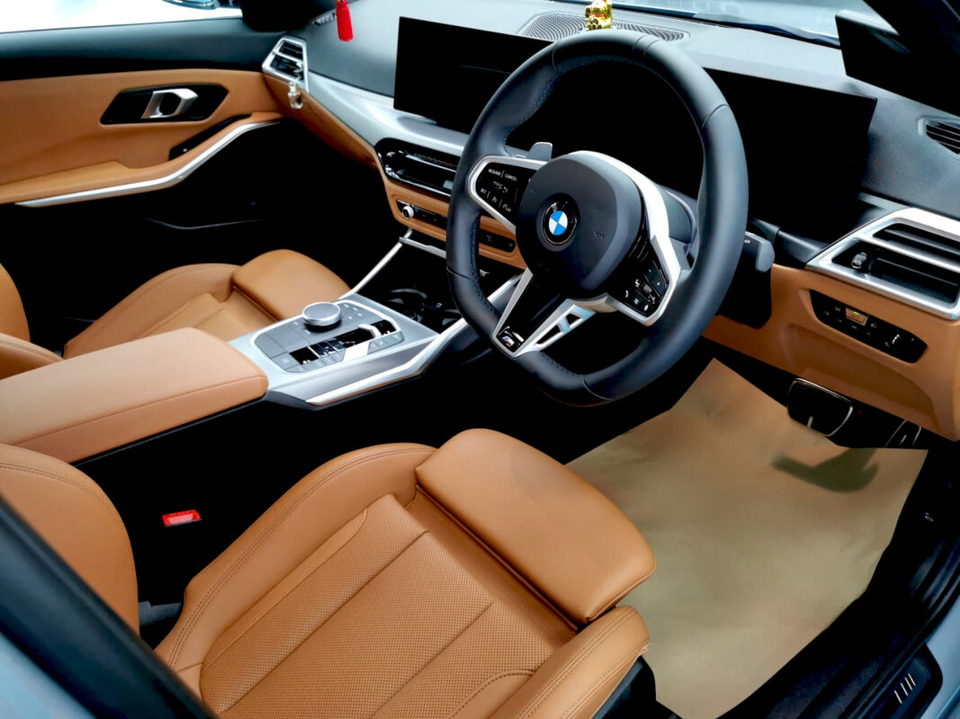 The BMW 318i parked in the workshop, freshly coated.
