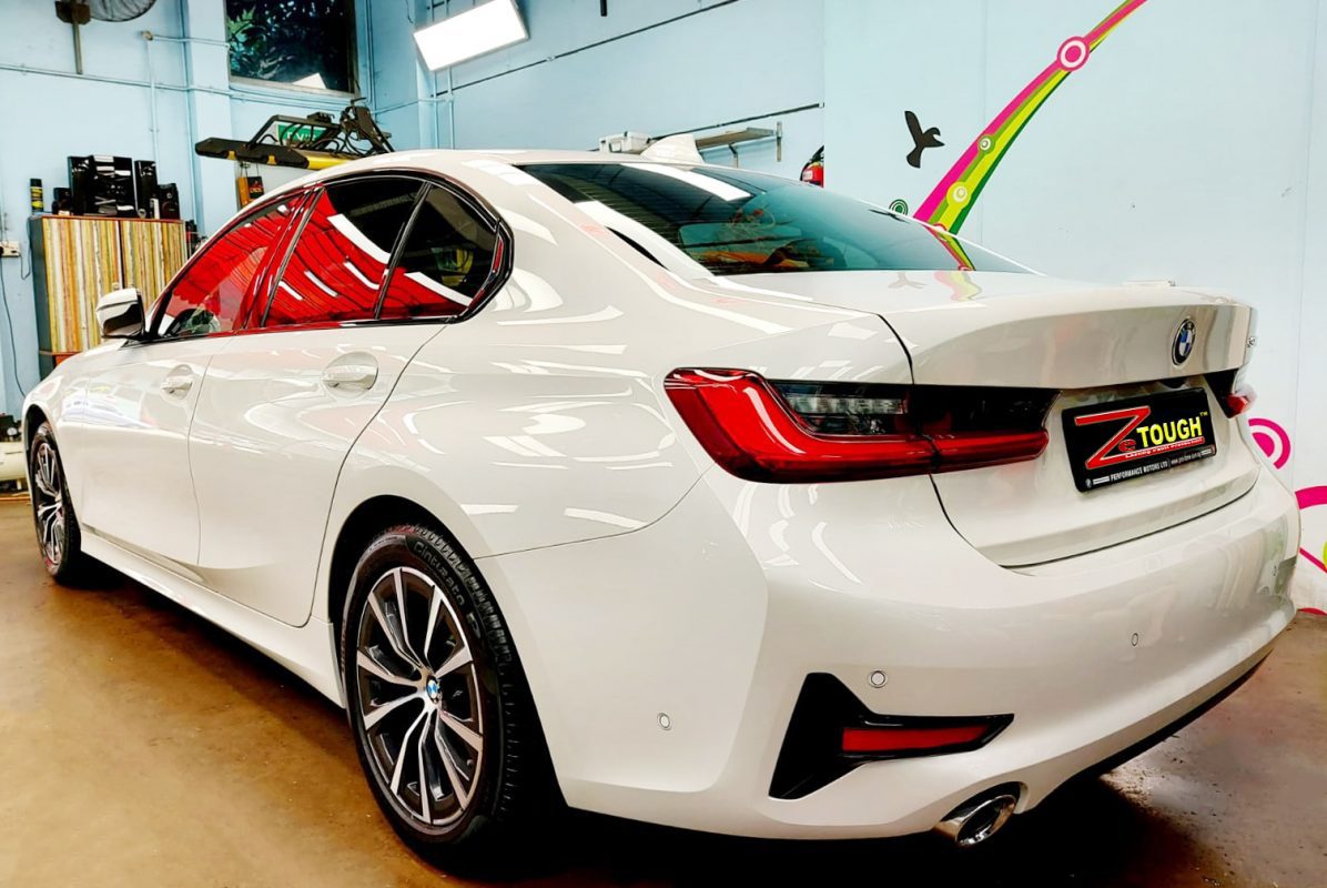 Rear quarter of the BMW 318i, glossy and protected.