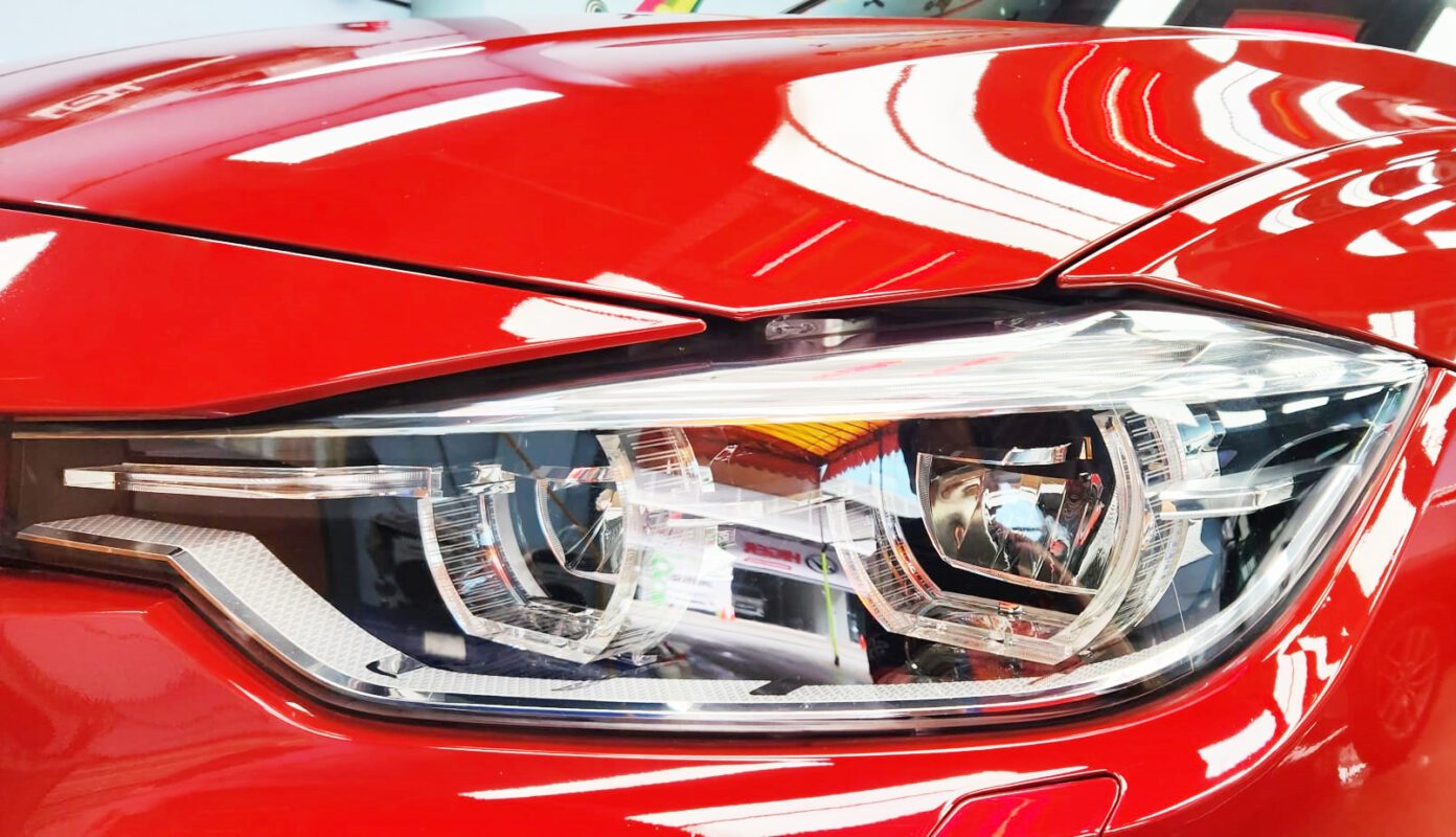 The 318i's coated paintwork showing clean reflections.