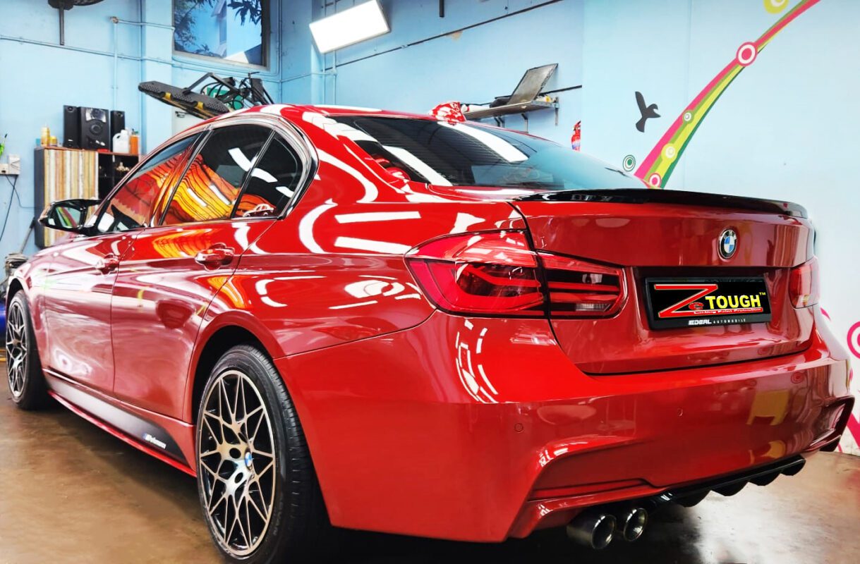 Rear quarter of the BMW 318i, glossy and protected.