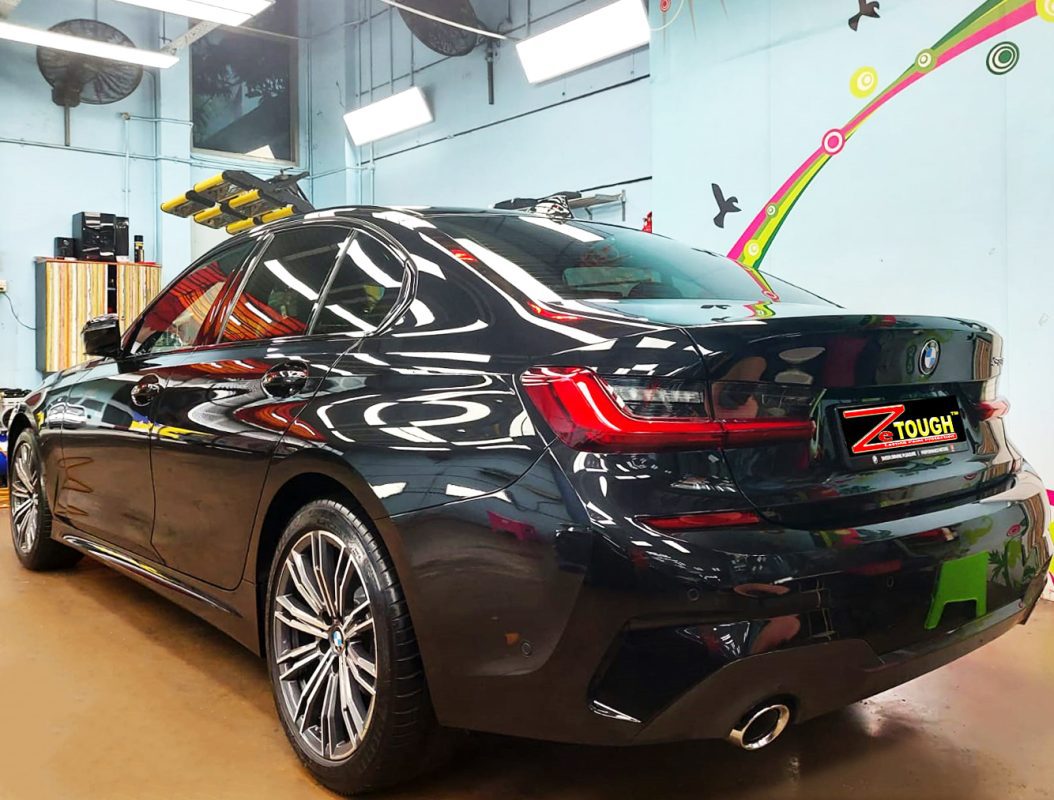 Rear quarter of the BMW 318i, glossy and protected.