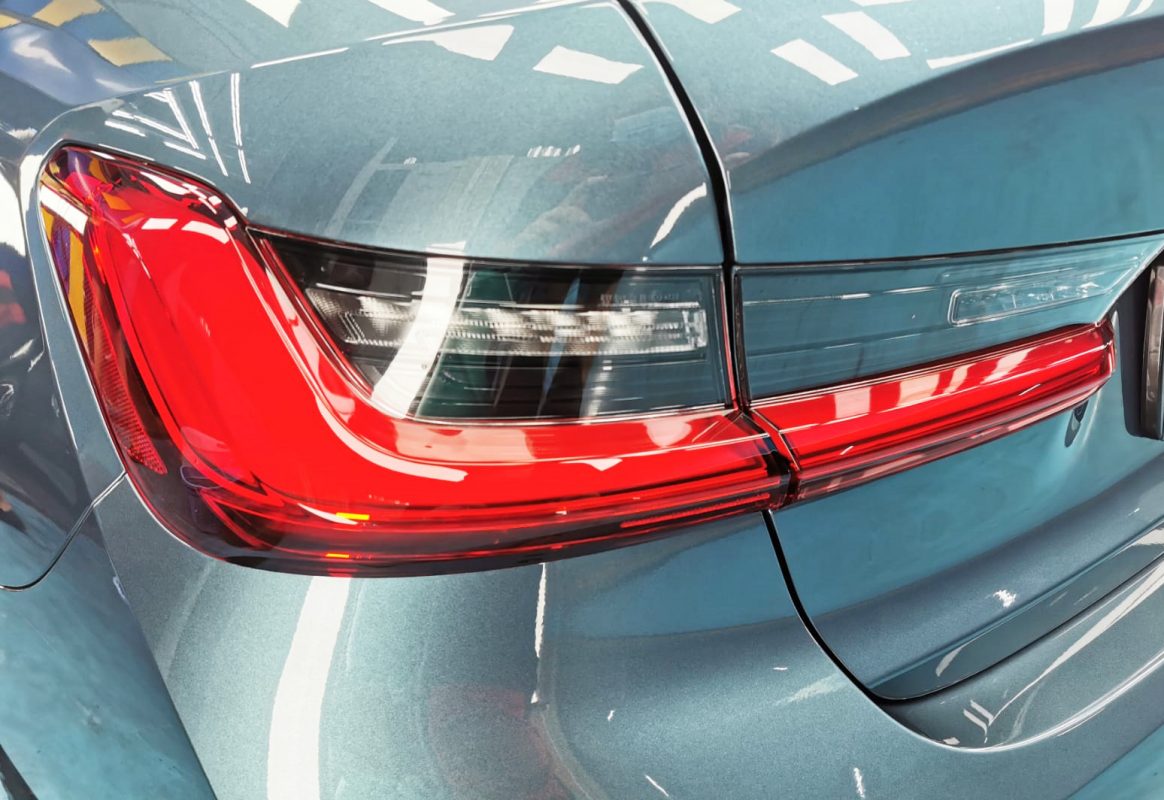 The coated bonnet of the BMW 3201 under workshop lighting.