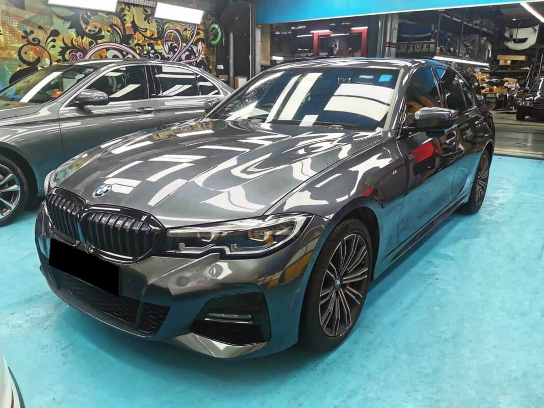The BMW 320i as it arrived at Revol Carz, showing faded and damaged paintwork.