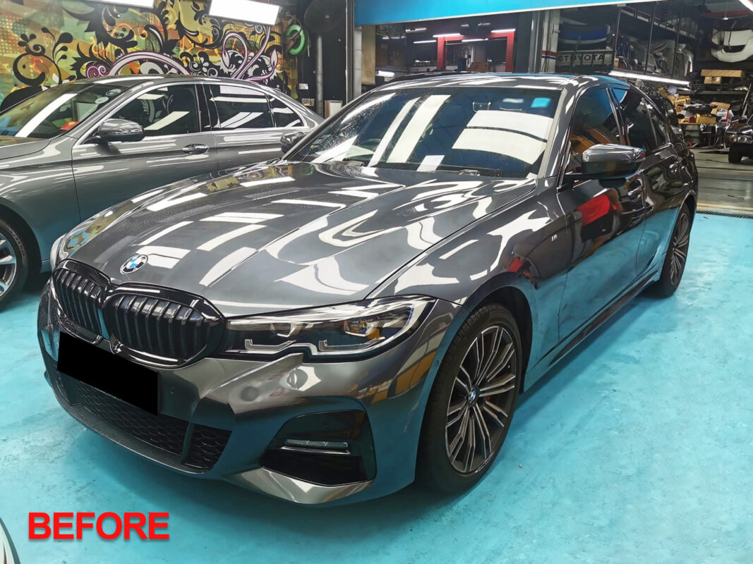 The BMW 320i being reassembled, parts refitted after the respray.