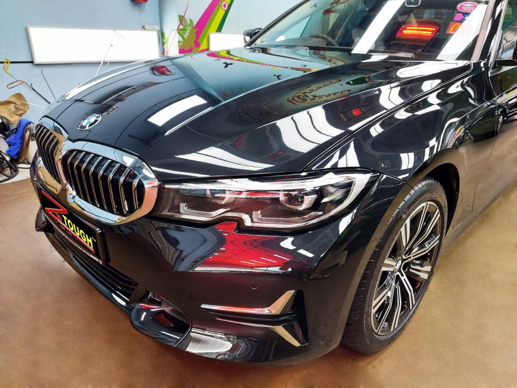 The BMW 320i from a side angle after the ceramic coating.