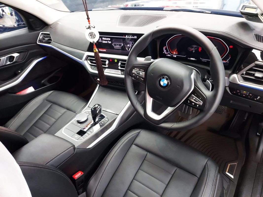 The BMW 320i parked in the workshop, freshly coated.
