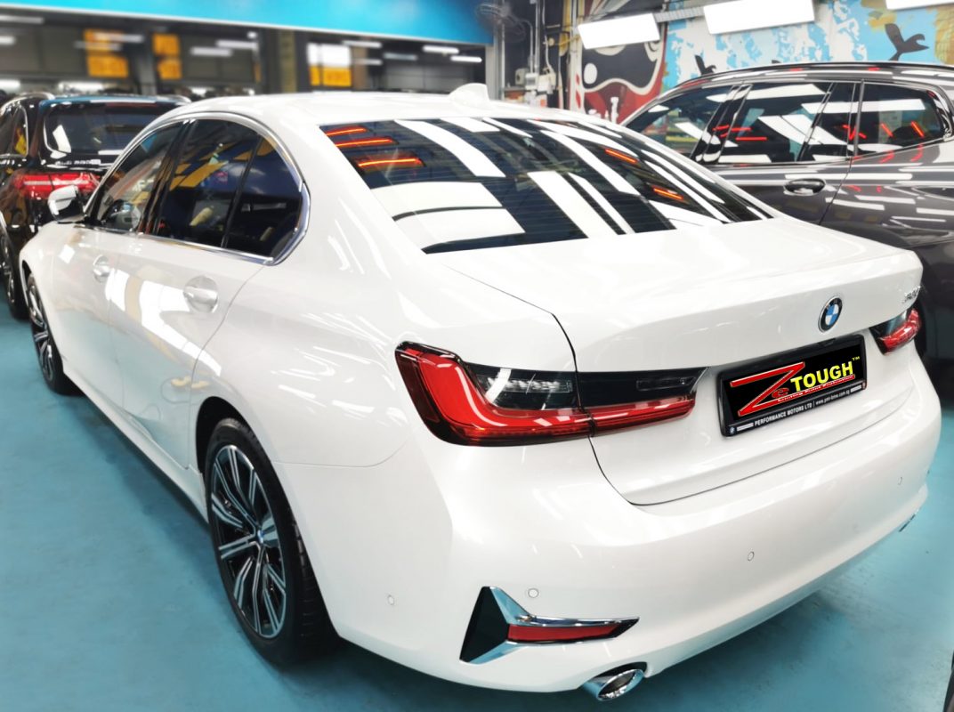 Rear quarter of the BMW 320i, glossy and protected.