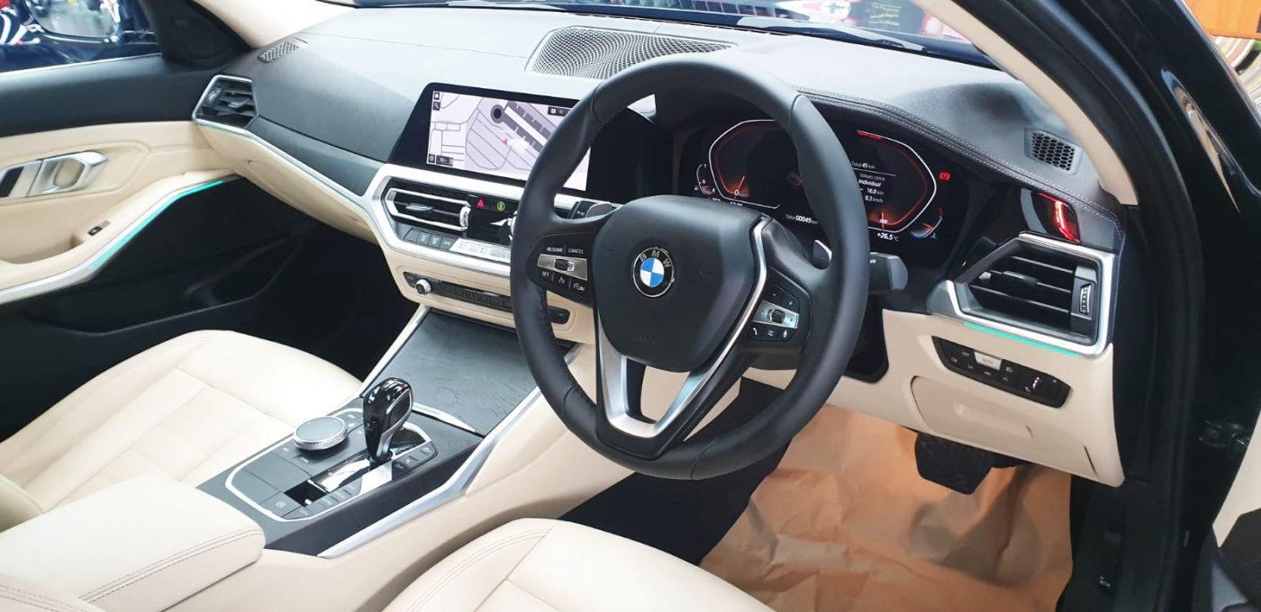 The BMW 320i parked in the workshop, freshly coated.