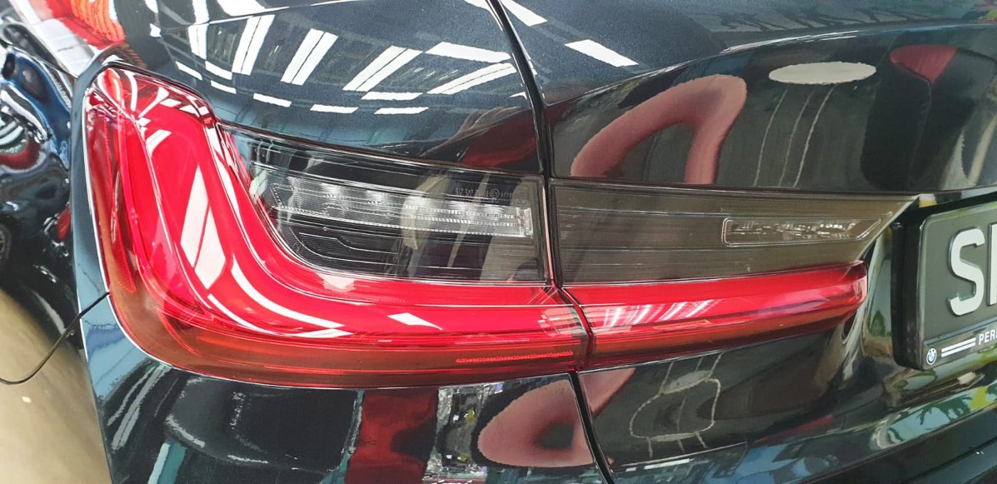 Rear quarter of the BMW 320i, glossy and protected.