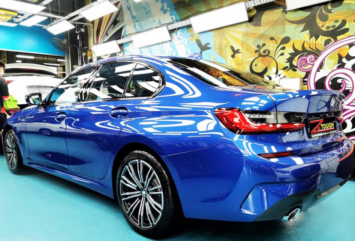 Rear quarter of the 320i, glossy and protected.