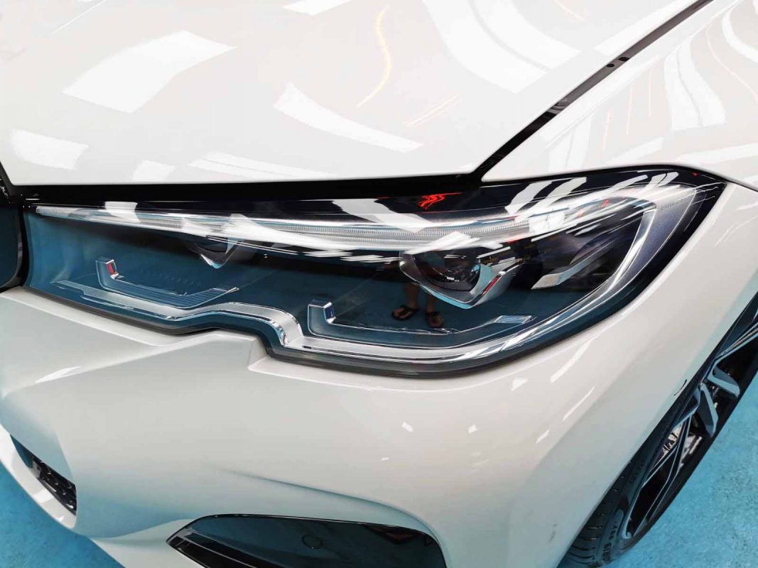 The 330i's coated paintwork holding clean reflections.